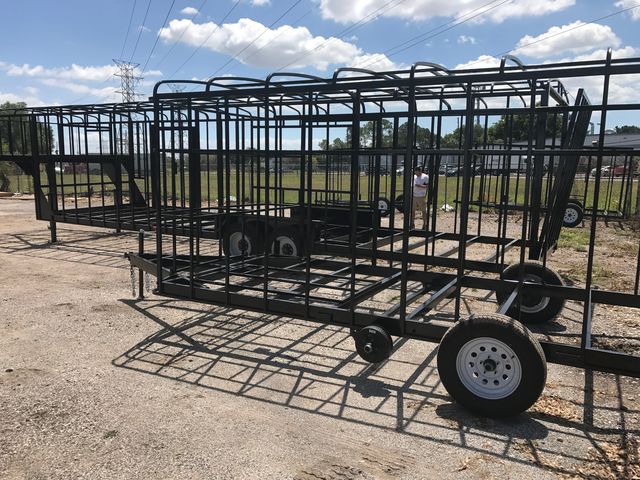 Bare welded steel frame of a gaming trailer on its axles in the Premier Gaming Trailers yard, before walls go on