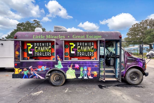 A second converted gaming bus from the side, with two exterior screen hatches open showing screens with the PGT logo, a satellite dome and an air conditioning unit on the roof, and a full character wrap along the body