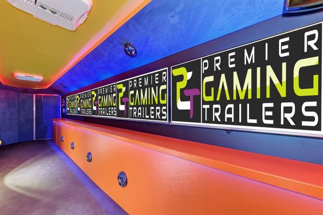 Inside a Gamers Utopia: PGT screens along one wall above an orange base, with a blue suede wall and a yellow ceiling edged with red LED light