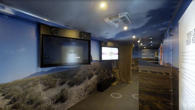 Inside the traveling museum trailer we built: desert photo murals and display panels down both walls